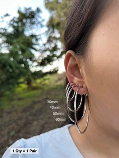 Item Details: This is for 1 Pair (= 2 Pieces). Size:  * 30mm  * 40mm  * 50mm  * 60mm  Item Details: The earrings are for 1 PAIR and only come in the CLIP-ON version for NON-PIERCED ears. These stainless steel clip-on hoop earrings use a spring closure and look very realistic (like pierced earrings). More color/size: * Silver Small (11-18mm): https://clipsody.etsy.com/listing/1447440109  * Gold Small (11-18mm): https://clipsody.etsy.com/listing/1427933739 * Gold Large (30-60mm): https://clipsody.etsy.com/listing/1732357881  * Rose Gold Small (11-18mm): https://clipsody.etsy.com/listing/1564368041  * Rose Gold Large (30-60mm): https://clipsody.etsy.com/listing/1718185720  Shipping: * US customers: Receive FREE US shipping by making an order of $35 or above from my shop. * Non-US customers: I Earrings No Piercing, Earrings For Men, Earrings Clip, Earrings Minimalist, Pierced Earrings, Silver Hoops, Pierced Ears, Minimalist Earrings, Earings Piercings