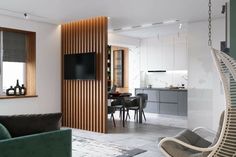 a living room filled with furniture and a flat screen tv mounted to the wall next to a window