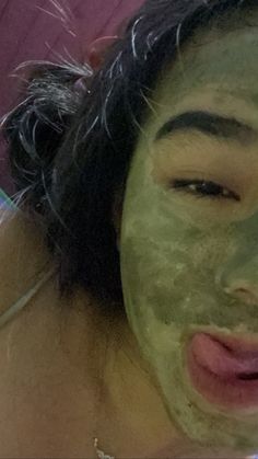 a woman with a green mask on her face