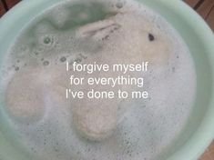 a white teddy bear in a green bowl with the words i forgive my self for everything i've done to me