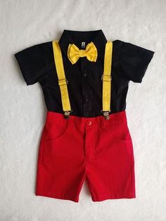 a black shirt and red shorts with yellow suspenders