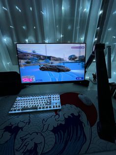 a computer monitor sitting on top of a desk with a keyboard and mouse in front of it