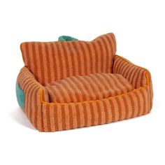 an orange and green striped dog bed with a pillow on the bottom, in front of a white background