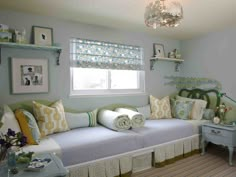 a bedroom with blue walls and white furniture