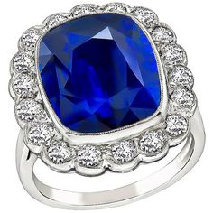 a blue cushion shaped ring with diamonds around it