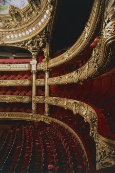 an ornately decorated auditorium with red seats