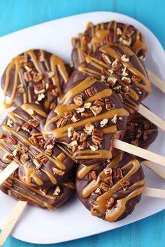 chocolate covered pretzels with caramel drizzle and nuts on skewers