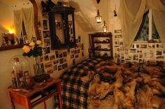 a bed room with a neatly made bed and pictures on the wall