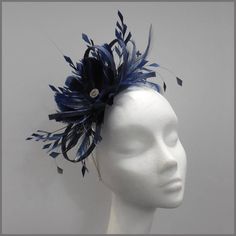 Navy blue sinamay and feather design fascinator. A good size headpiece for all occasions with a pretty selection of feathers and delicate silver leaf jewels. Made on a headband.  Designs can be made to order in a range of different colours or styles, see our colour chart: www.jacquivaledesigns.com/colour_chart.html Please contact me if you would like a design in a different colour. We can make a range of ladies hats, fascinators and accessories for any type occasion. Such as weddings, proms, chr Blue Feather Trim Fascinator For Kentucky Derby, Blue Feathered Headpiece For Party, Elegant Blue Headpiece With Feather Trim, Blue Feathered Headband Fascinator, Blue Feather Trim Headpiece For Wedding, Blue Wedding Headpiece With Feather Trim, Blue Feather Fascinator For Races, Blue Feathered Fascinator For Races, Blue Feather Fascinator For Kentucky Derby