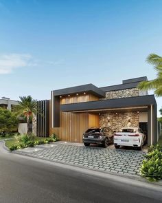 two cars parked in front of a modern house with stone and wood accents on the exterior