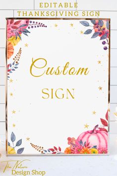 a sign that says, custom sign with flowers and leaves in gold foil on a white background