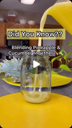 a glass filled with liquid sitting on top of a yellow countertop next to a banana