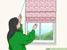 a woman is looking out the window with her hand on the roller blinds that are pink