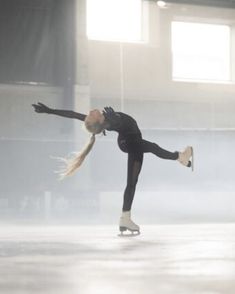 a female figure skating on an ice rink