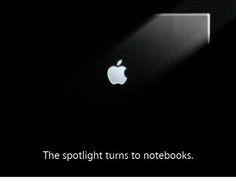 an apple logo is shown on the back of a macbook pro with text that reads, the spotlight turns to notebooks