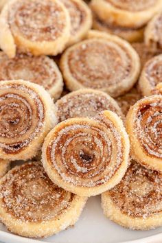 cinnamon rolls on a white plate with powdered sugar sprinkled on the top