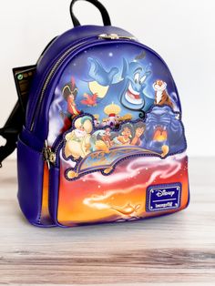 Disney Aladdin 30th Anniversary Mini Backpack - Whiskey Skies Character Style Backpack For Disney Fan Events, Blue Character Backpack For Disney Trips, Themed Multicolor Backpack For Theme Park, Disney Multicolor Backpack For Theme Park, Multicolor Disney Backpack For Theme Park, Back To School Backpack For Disney Fan Events, Disney Backpack With Case For School, Disney Character Print Standard Backpack, Disney Backpack For School With Case Included