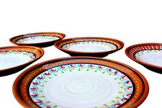 five colorful plates sitting on top of each other