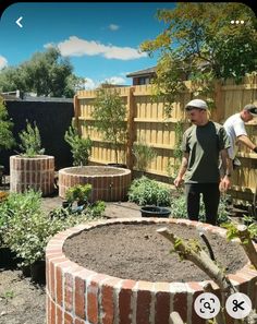 two men are working in the garden together