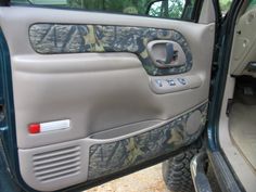 the interior of a vehicle with camouflage paint and door handles on it's doors