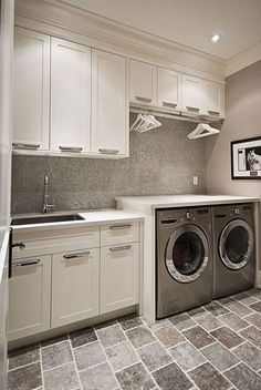 a washer and dryer sitting in a kitchen next to a counter top oven