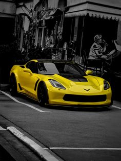 a yellow sports car is parked on the street