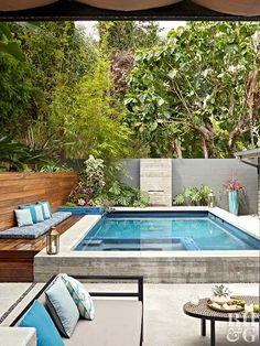 an outdoor living area with a pool and patio furniture