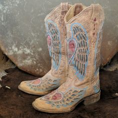 Women's Corral Cowgirl Boot In Distressed Antique Saddle Leather. Wing & Heart Cut Out Designs With Blue Jean Blue And Vintage Red Leather Inlays Cover The Foot And 13" Upper Shaft. Style #A1990, Part Of Corrals Vintage Line. Intentionally Created By Maker To Look Aged/Vintage. This Boot Has A Square Toe, 1.5" Roping Heel, Leather Sole, Lightly Cushioned Leather Insole And Fully Leather Lined With Super Soft Quality Pigskin Leather. Handcrafted In Mexico, Amazing Quality & Workmanship. Sz 6.5 M (Ladies Regular Great Pre-Owned Condition, Worn About 20-25x, Never Had Spurs On Them. Light-Moderate Wear On Leather Soles & Light Wear/Drag On Heel Caps. Some Dirt Stuck In Tiny Grooves Of Hee Heart Cowgirl Boots, Corral Cowgirl Boots, Leather Wings, Cowgirl Boot, Heart Cut Out, Saddle Leather, Heel Caps, Pig Skin, Cut Out Design