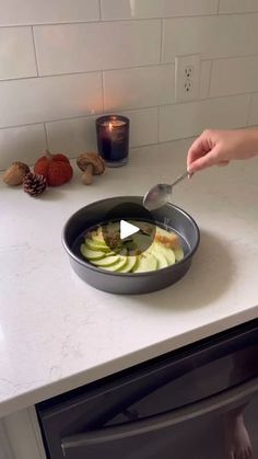 someone is cooking food in a pan on the kitchen counter