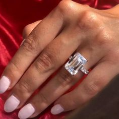 a woman's hand with a diamond ring on it