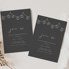 two black and white wedding cards with string lights