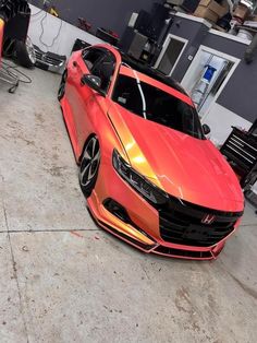 an orange car is parked in a garage