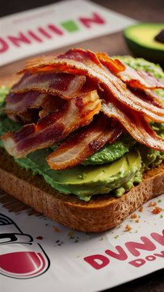 a bacon and avocado sandwich is on a plate