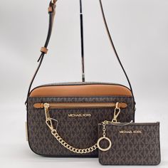 Brand New With Tag Michael Kors Large Ew Zip Chain Xbody Michael Kors Lg Ew Zip Chain Crossbody Bag Pvc And Saffiano Leather Zippered Top Closure Color: Brown Signature Gold -Tone Hardware Michael Kors Lettering Logo On Front Inside: 1 Large Padded Pocket, & 1 Slip Pockets Outside: 1 Back Pocket And 1 Zip Pocket And 1 Slip Pocket On The Front Mk Signature Fabric Lining L: 9.5" X H: 6.2" X W: 2" W/ Adjustable 22” Leather Crossbody Strap Does Not Include Dust Bag Wallet: 100% Authentic This Is An Michael Kors Crossbody Bag, Card Case Wallet, Michael Kors Crossbody, Chain Crossbody Bag, Wallet Phone Case, Purses Michael Kors, Kors Jet Set, Michael Kors Jet Set, Michael Kors Bag