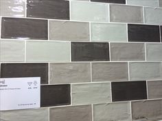 a white and brown tile wall with a price tag on it