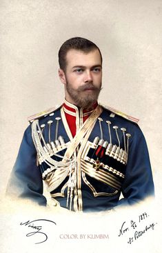 a man with a beard wearing an uniform and standing in front of a white background