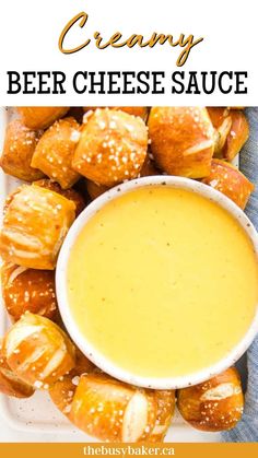 a white plate topped with croissants covered in cheese sauce