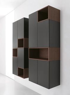 an empty room with some shelves on the wall and one shelf in the middle that has several cubes attached to it