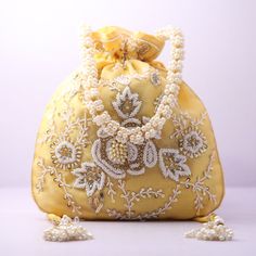 Material:Silk, Golden Tread, Golden Sequins, Motifs Color: Pink, Orange, Yellow, Blue Package Contents: As per quantity purchased Designed with the heart, this beautiful Potli or batawa bag are eye catchy and made of premium material. Key Features: Embroidery art work. This potli is good match with both Indian and western outfits and are superb for wedding and festive parties. This would be best complement to your designer saree, lenhga or any other kind of dress. This is the combination of trad Elegant Pearl Embroidered Fabric For Celebration, Festive Embellished Potli Bag As Gift, Traditional Beaded Bag For Party, Beaded Potli Bag For Festivals And Gifts, Festival Beaded Potli Bag As A Gift, Beaded Potli Bag For Festivals Gift, Beaded Rectangular Potli Bag For Festive Occasions, Traditional Embellished Evening Bag For Festivals, Embroidered Evening Bag For Festivals