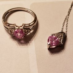 Gorgeous 10k White Gold Ring With Pink Heart Shaped Sapphire And 3 Diamonds On Each Side. Matching Necklace. Excellent Condition! Minor Scratches On Band As I Wore This All The Time. The Necklace Has Been In Storage As The Chain Is Too Short. Small Knot In Chain As Pictured. Both Items Have Been Cleaned And Sanitized For Your Safety. All Items Come From A Smoke Free But Pet Friendly Home And Are Cross Posted. Please Let Me Know If You Have Any Questions Or Concerns. Happy Shopping! Heart Shaped Diamond Ring, Helzberg Diamonds, Heart Shaped Diamond, White Gold Ring, Matching Necklaces, Too Short, Diamond Heart, Pink Sapphire, White Gold Rings