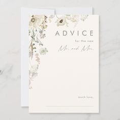 an advice card with flowers and leaves on the front, sitting on top of a marble surface