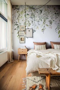 a bedroom with white walls and wooden floors