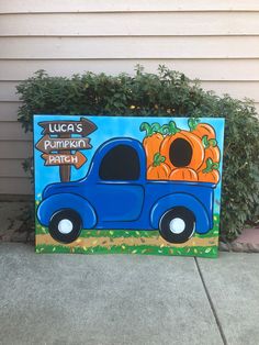 a blue truck with pumpkins painted on it