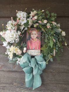 a wreath with flowers and a photo on it