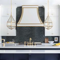 a kitchen with white cabinets and blue stools in front of the island countertop