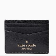 a black card case with the name kate spade new york on it's front