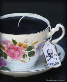 a tea cup with a skull and crossbone tag on it