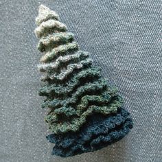 a crocheted christmas tree sitting on top of a table