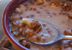 a bowl filled with cereal and nuts on top of a table