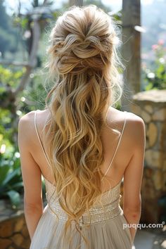 a woman with long blonde hair wearing a white dress and looking at the trees in the background